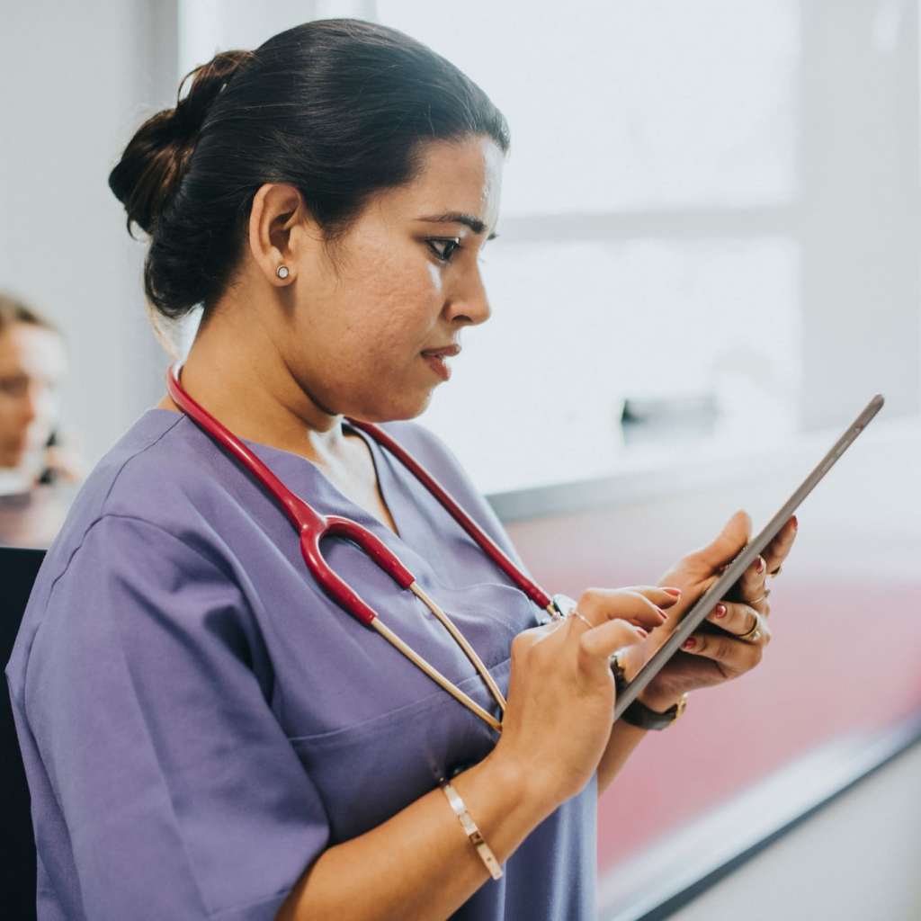Female nurse checking the schedule on a tablet