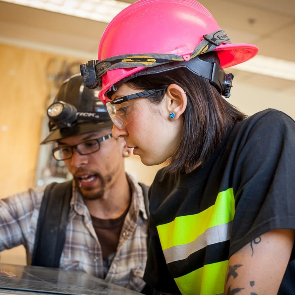 man-woman-working-on-equipment
